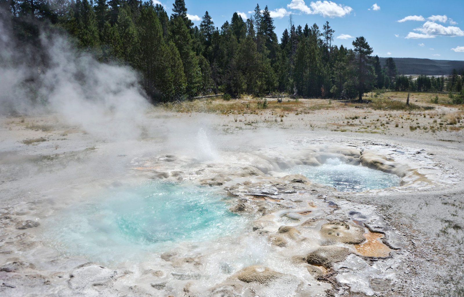 Explore the vibrant geysers and steaming landscapes at Yellowstone National Park, USA.